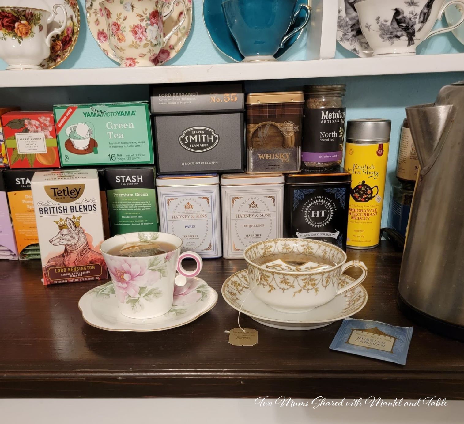 Closeup of teacups on counter with tea boxes in the background