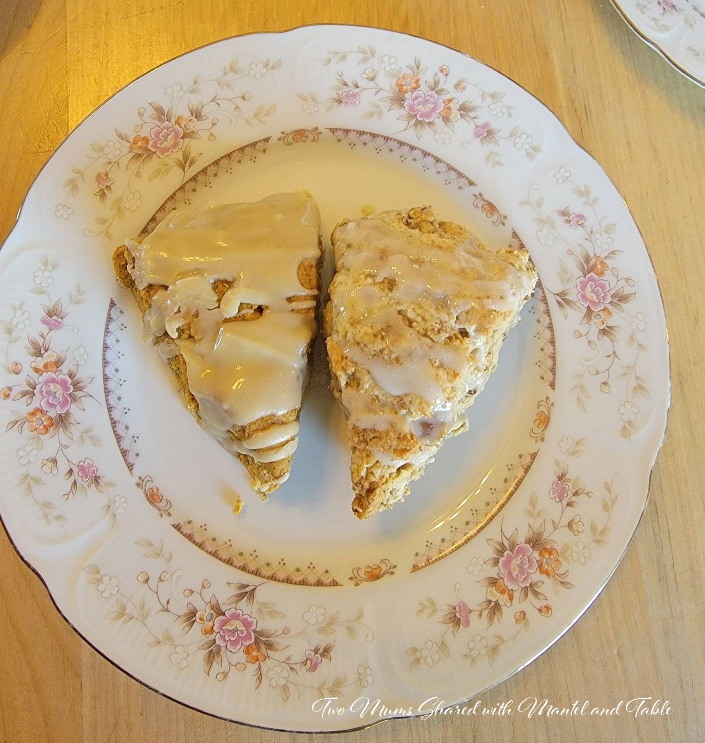 Two frosted scones on a pink floral china plate