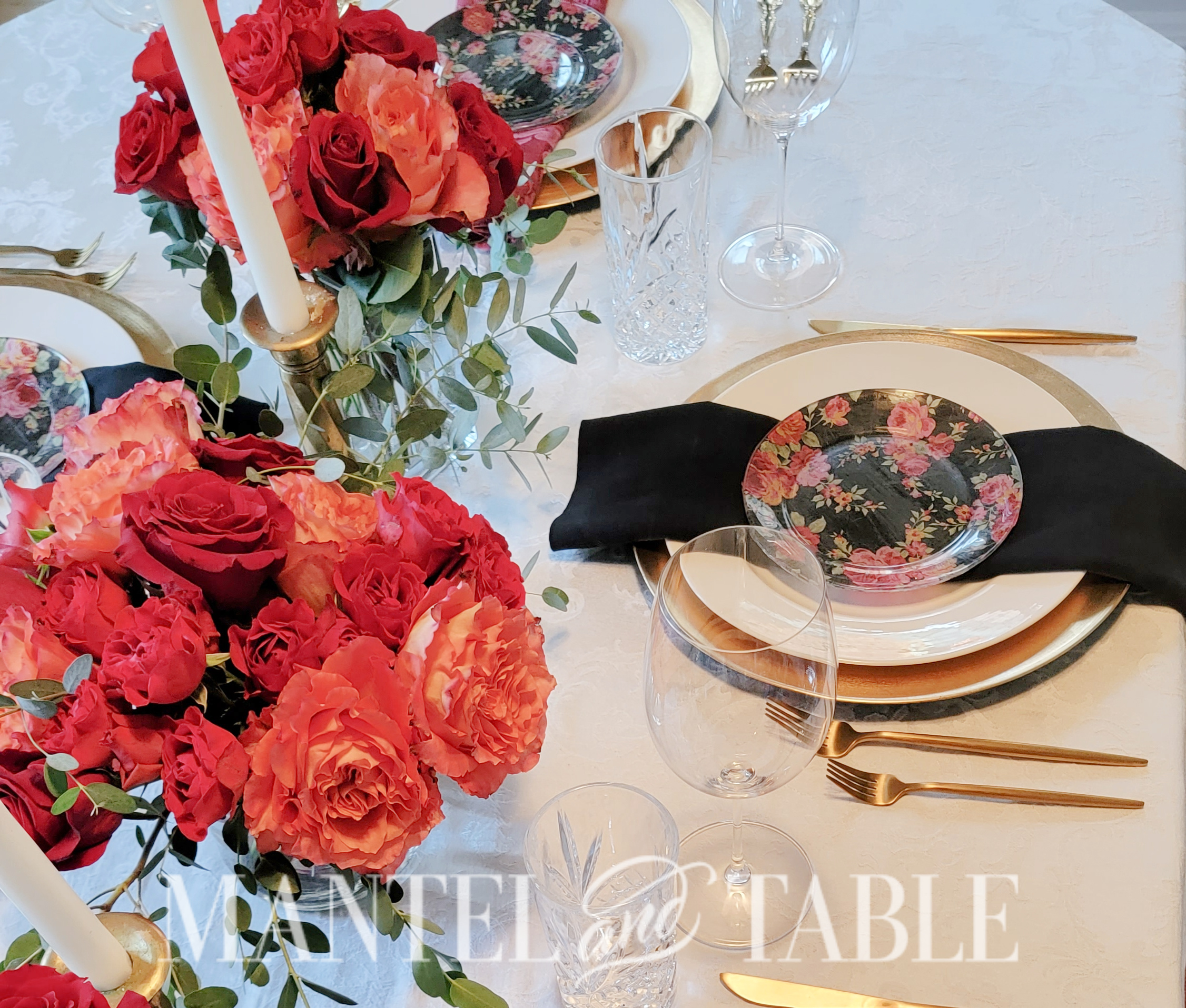 Table setting with orange and red roses
