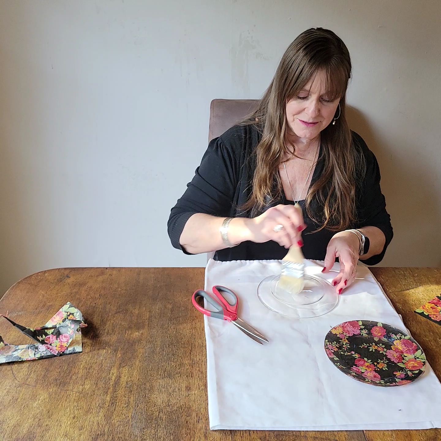 Two table setting problems solved! Woman brushing glue onto back of plate