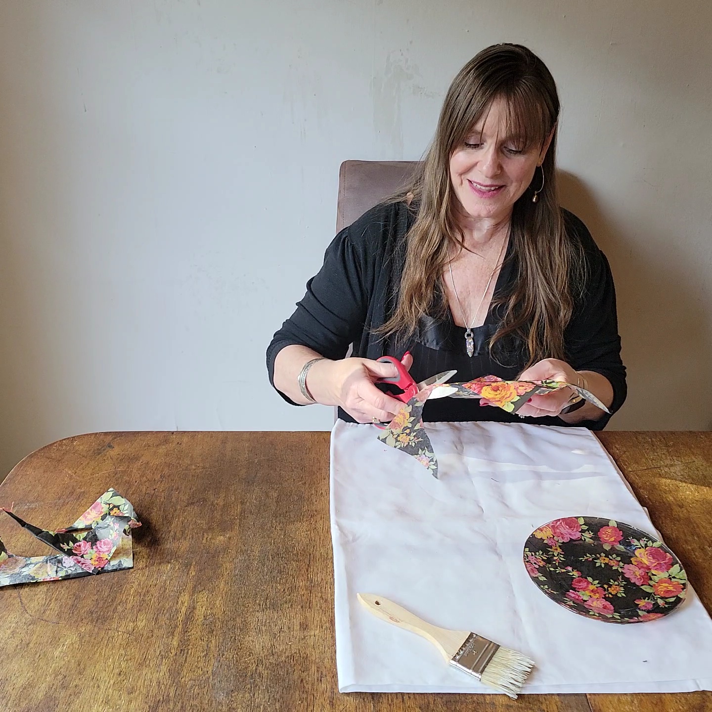 Two table setting problems solved! Woman cutting overhanding tissue paper from a plate