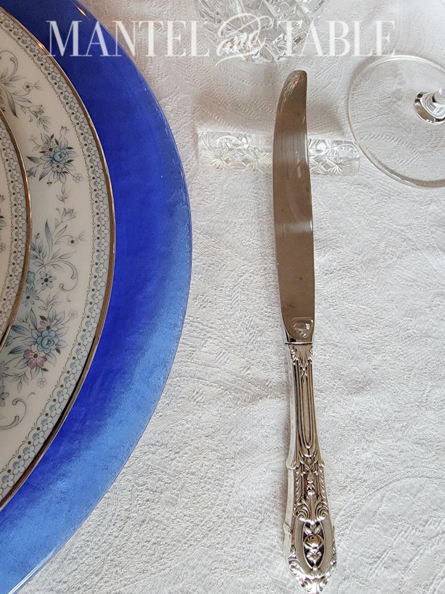 Silver table knife on a crystal knife rest