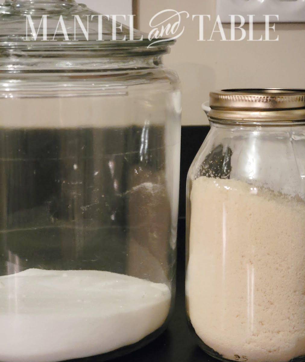 Sugar canister and jar of toasted sugar on black counter