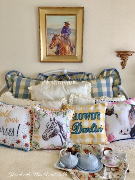 Teacup on breakfast tray on bed with painting of man on horse on the wall