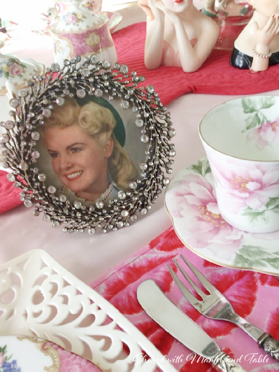 Teacup on the ranch posing on a tea table with framed photo of lovely young woman