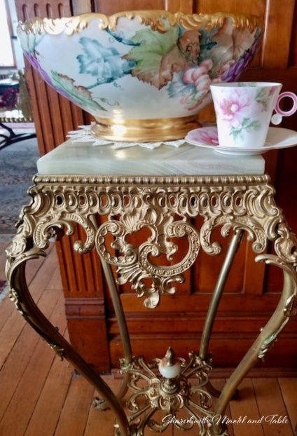 Teacup on the ranch, posing with an antique painted punch bowl on a marble table