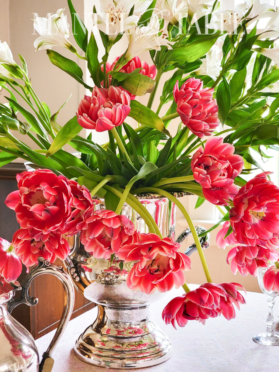 Organize a tea party - deep pink tulips in a silver wine bucket