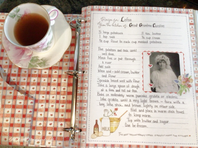 Teacup next to a family recipe book with 1800's wedding photo