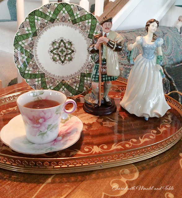Teacup on the ranch on tray with Scottish figurines