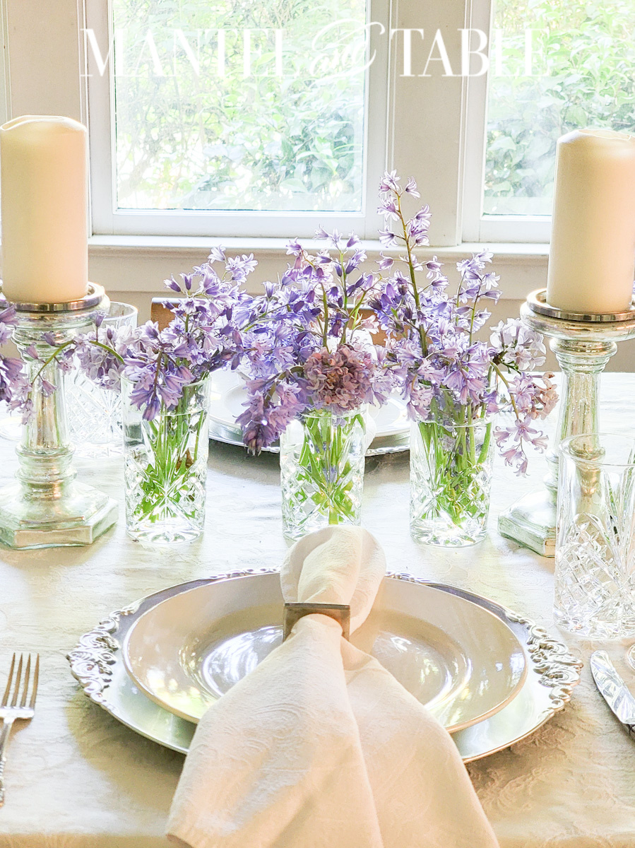 Purple flowers in crystal glass vases for table centerpiece