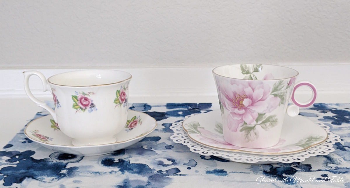tea and friendship - two rose teacups on blue runner