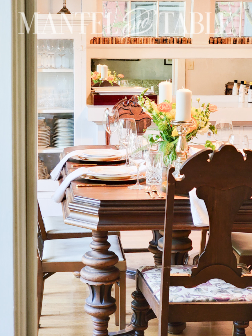 Table set for a formal dinner seen through a doorway