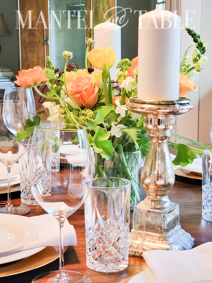 Wine and water glasses on a table with beautiful birthday flowers in arrangement