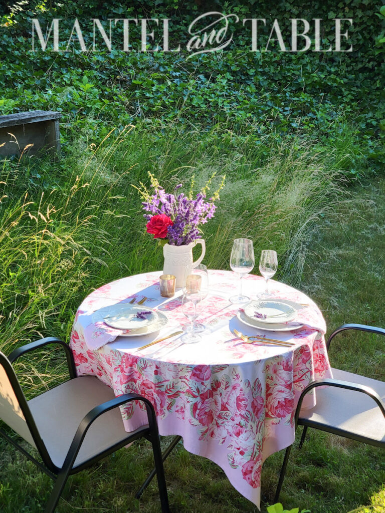 lavender bouquet in white pitcher decorating an outdoor table set for dinner