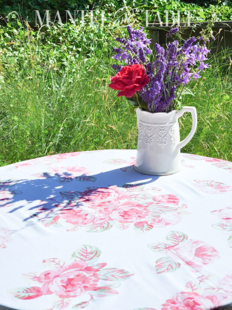 lavender bouquet in white vase on rose tablecloth