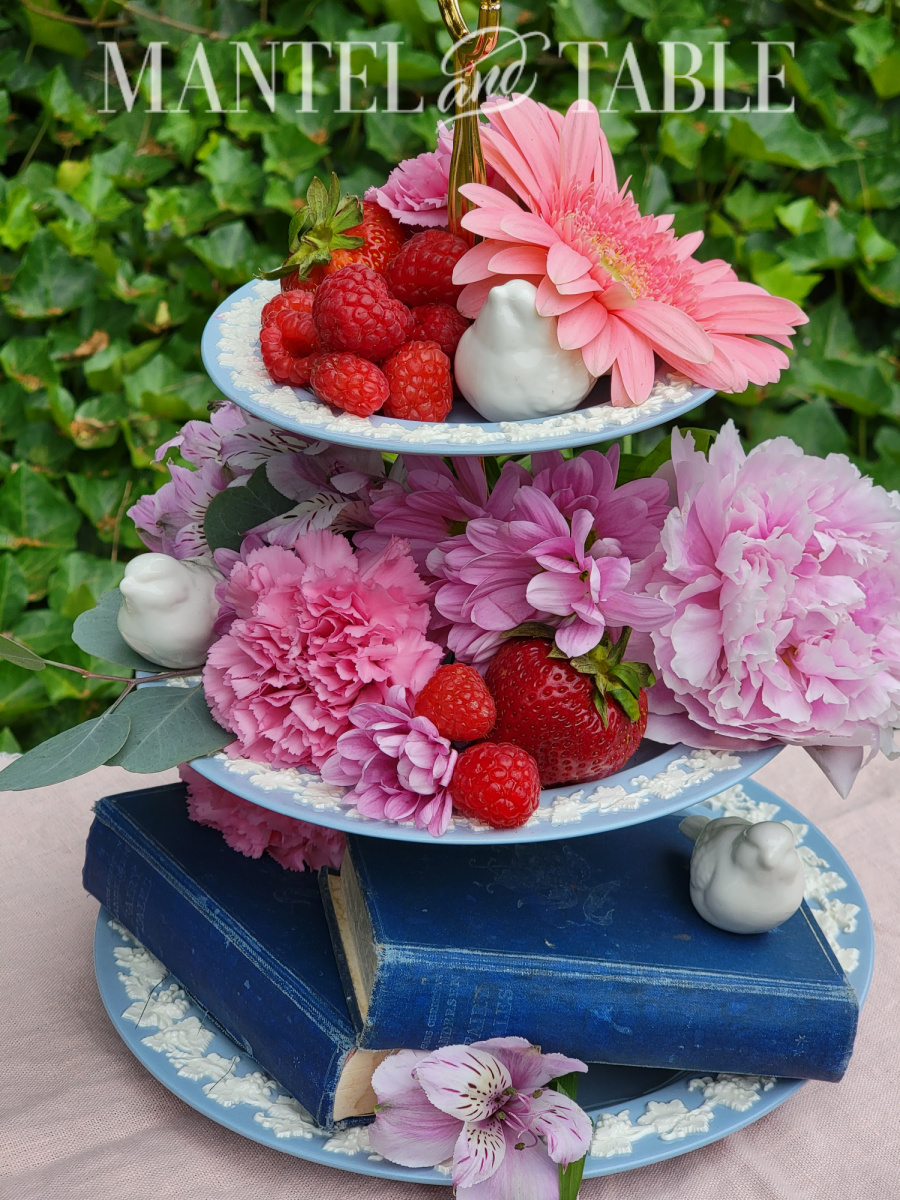 Summer tray decor - pink flowers, red berries, white ceramic birds, blue books on a 3-tiered tray