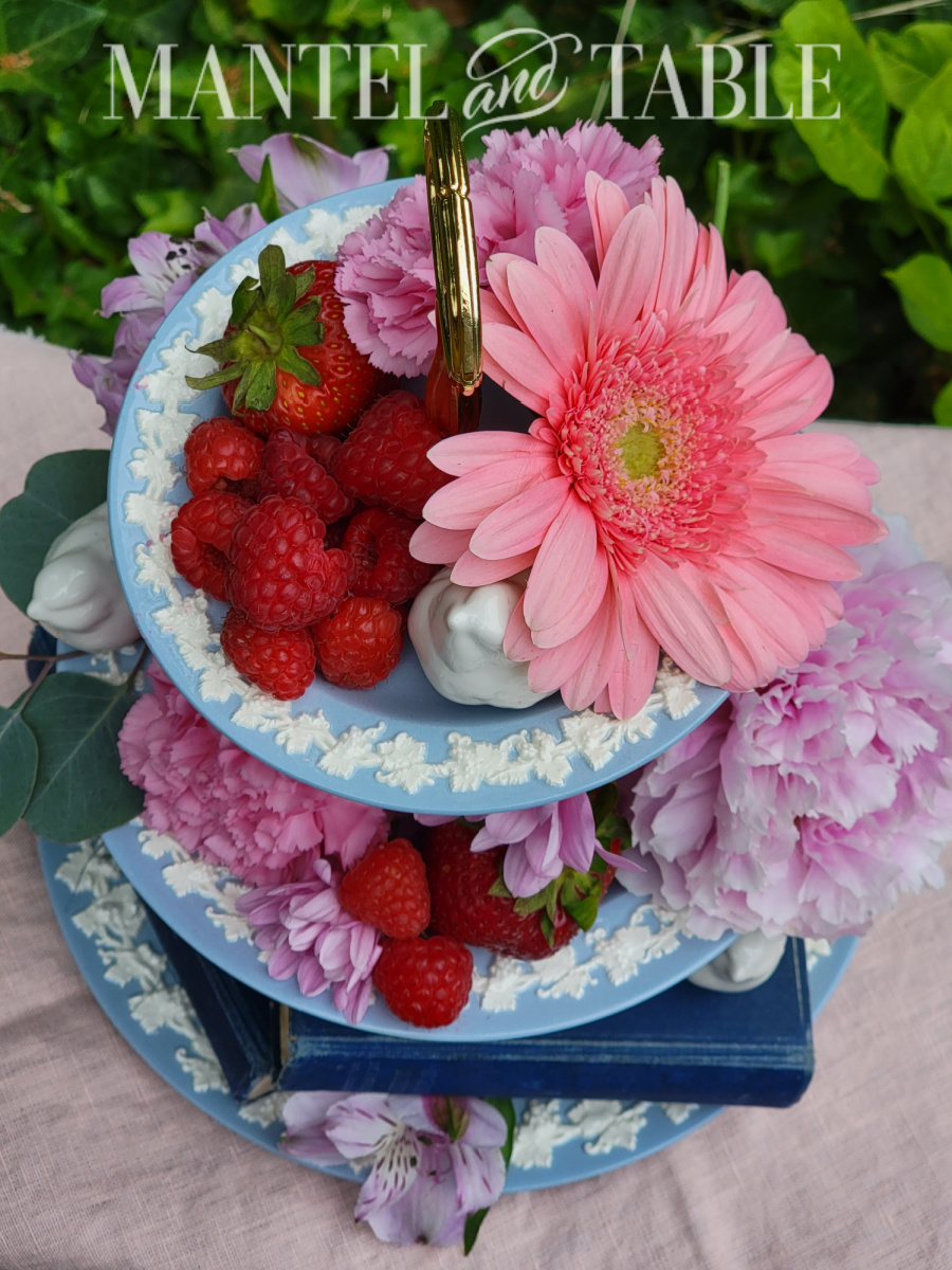 Pink and purple flowers, red berries on Wedgwood powder blue tiered tray top view