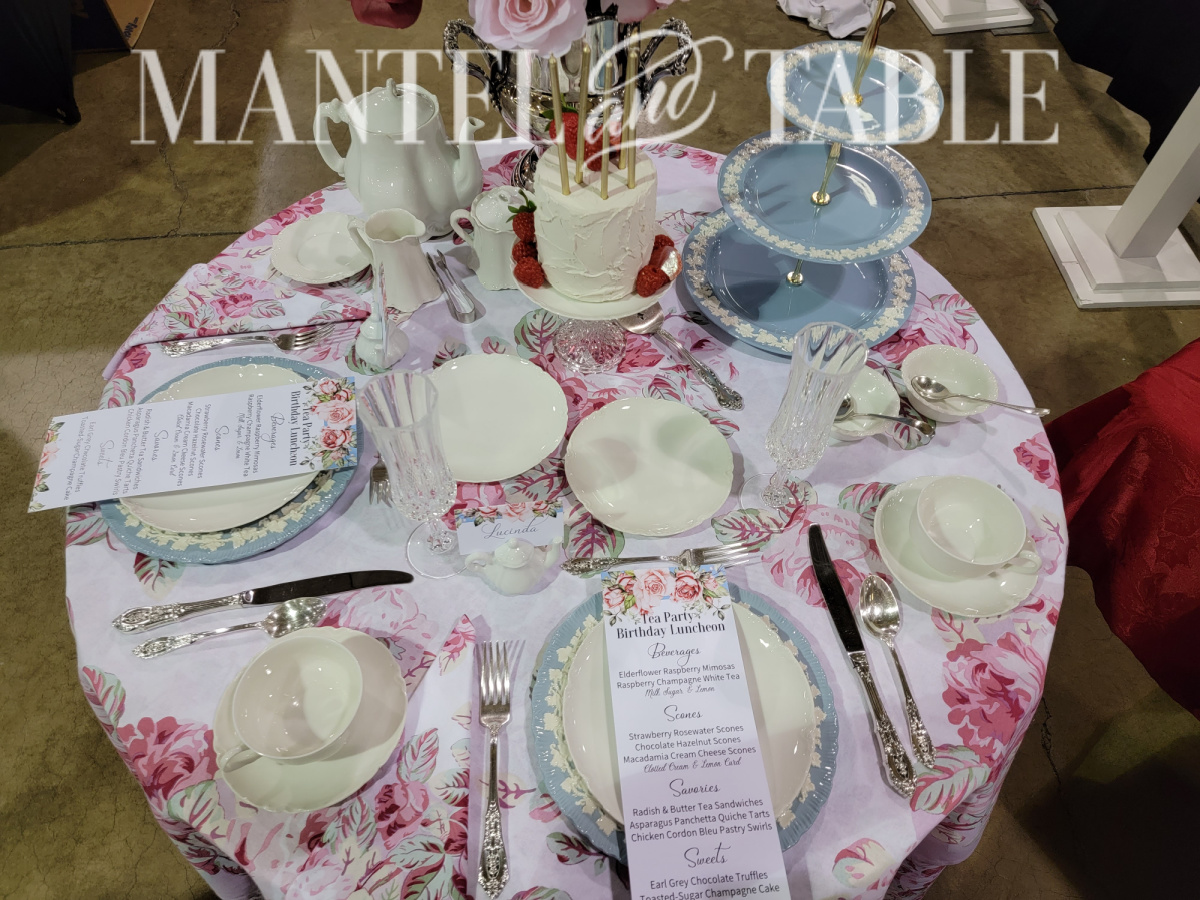 Tablescape Competition Judging - top view of table set with pink floral linens and blue and white dishes