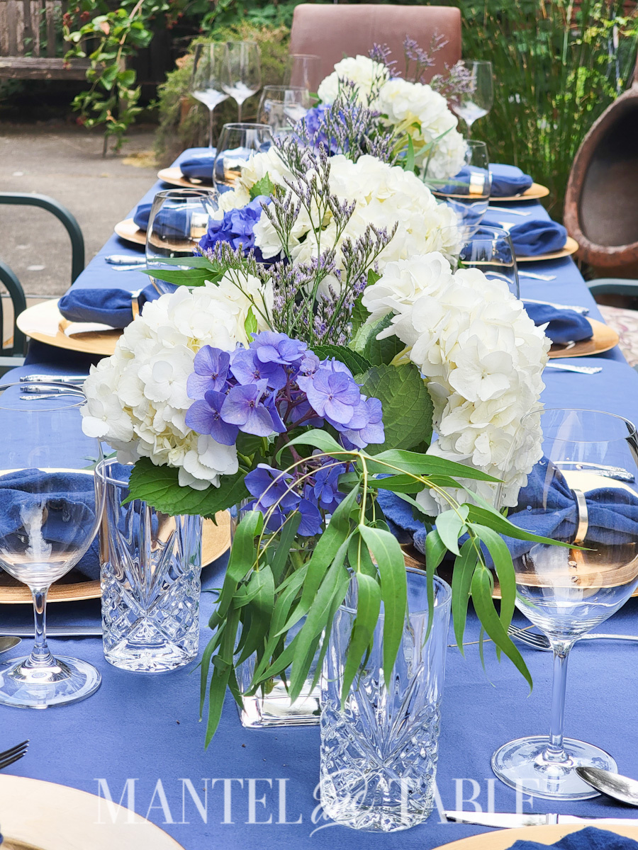 Last minute party - closeup view of flower centerpieces on a long table