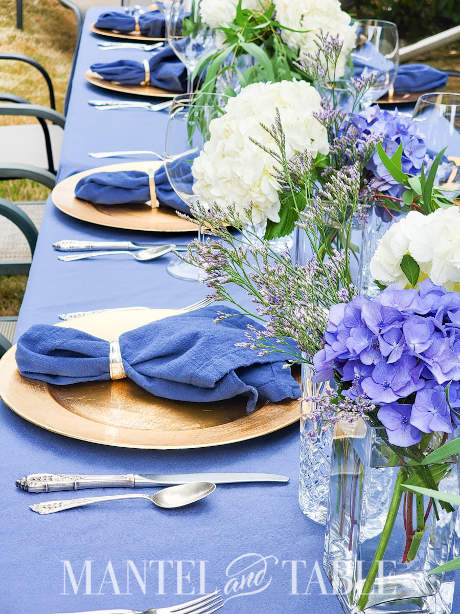 Last minute party - side view of blue and gold tablescape with blue and white flower centerpieces