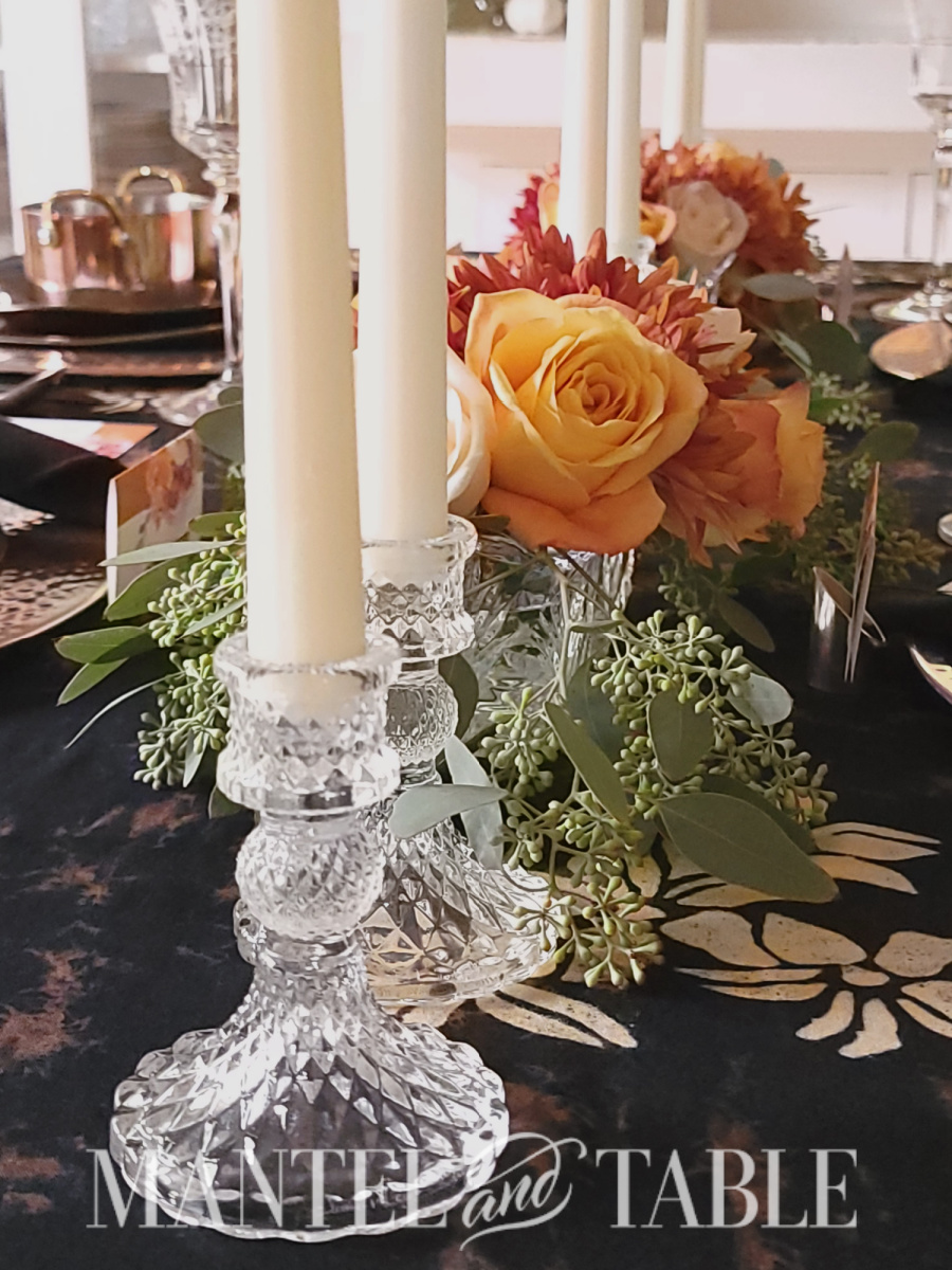 Closeup of crystal candle holders and flower centerpiece on Copper fall tablescape