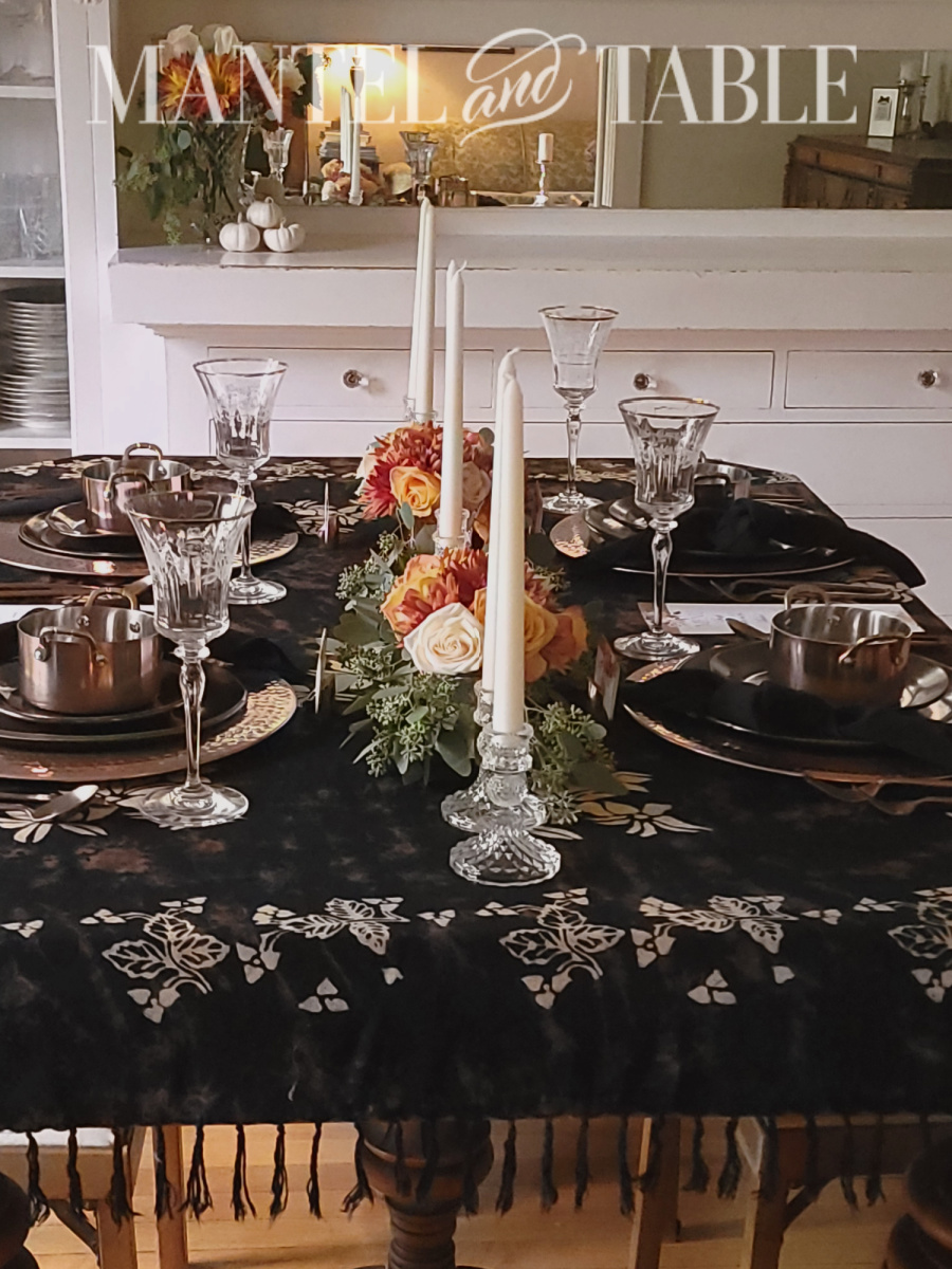 Side view of formal table with copper setting and flower centerpiece