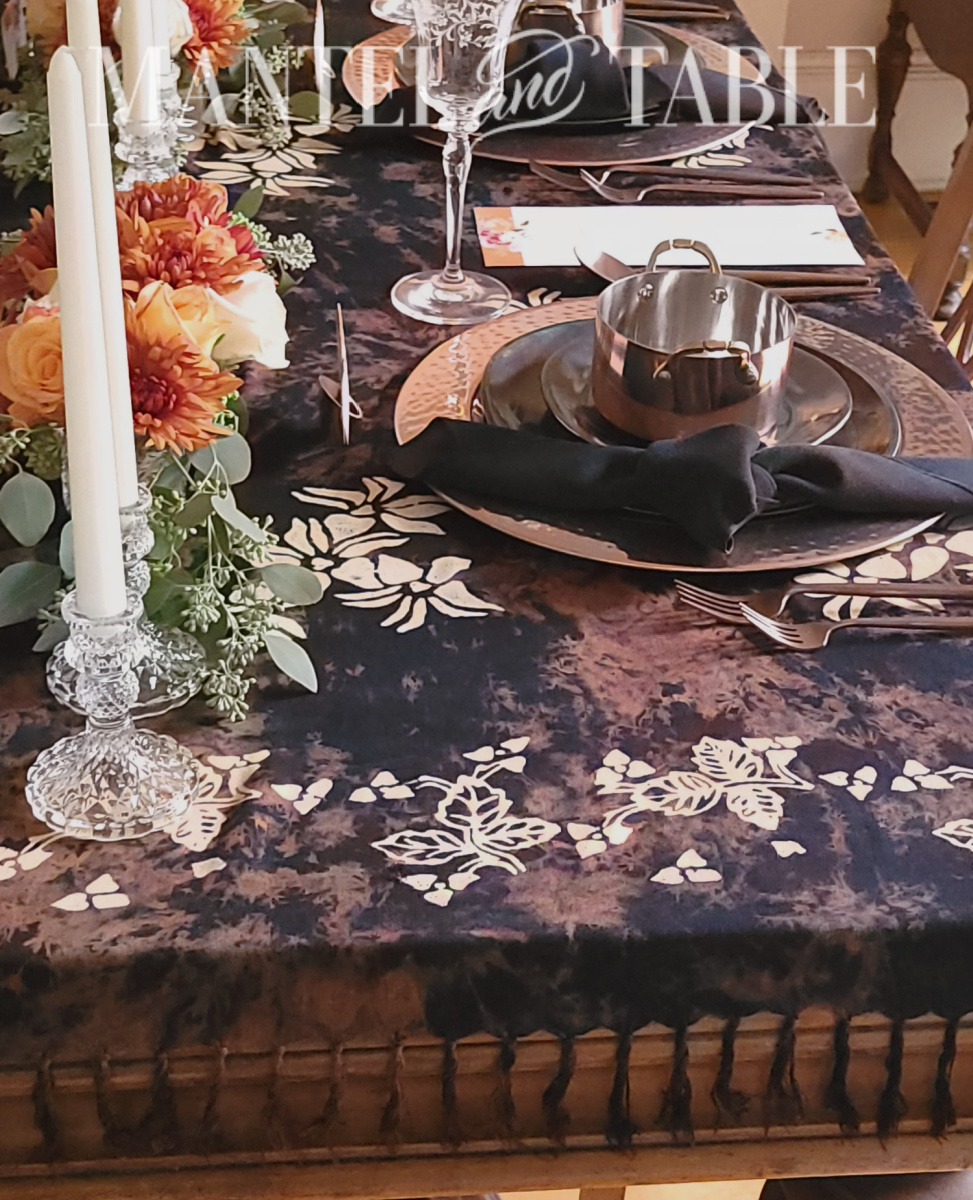Side view of formal table setting in black and copper