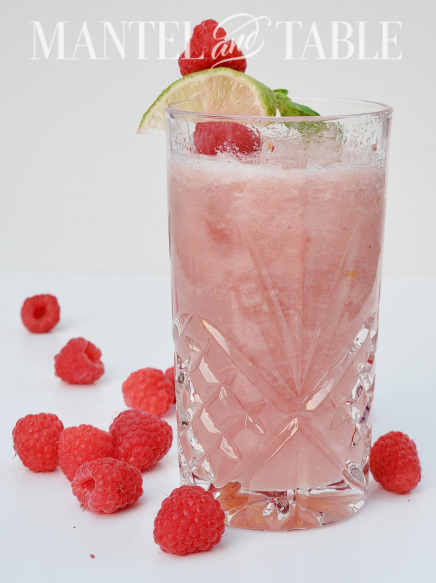 Tiger melon cocktail in crystal glass with raspberries