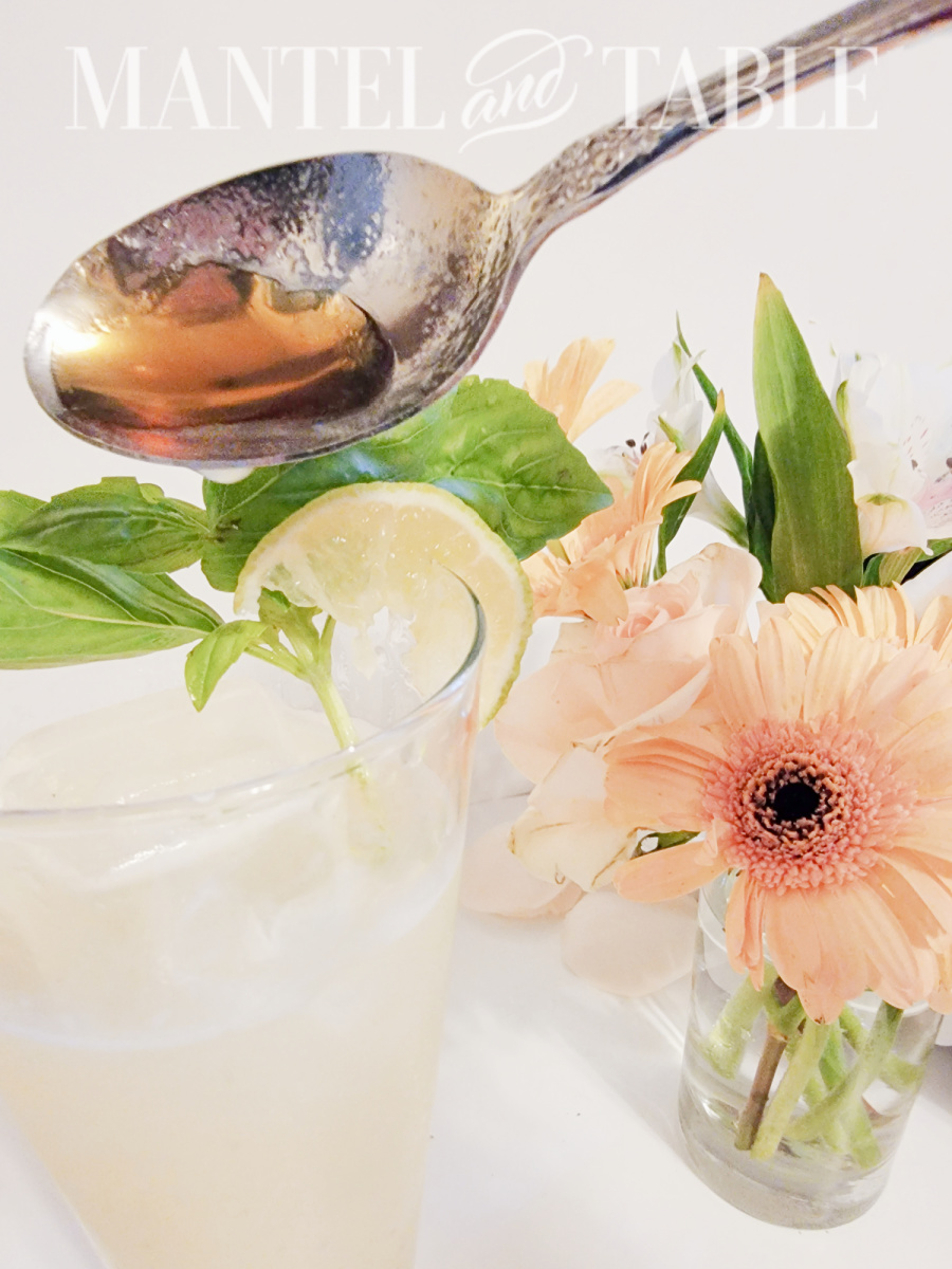 Spooning honey into cocktail glass