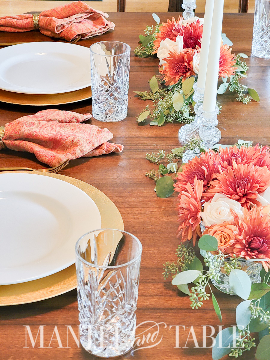 Fall Gold Tablescape - view across two place settings with centerpiece and candles