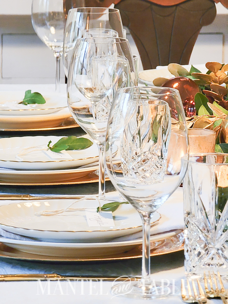 Wine glasses asnd crystal water glasses lined up on a formal table setting