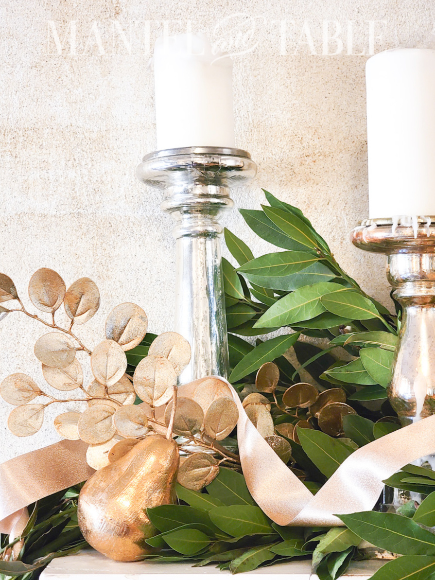 gold mantel decor including gold ribbon