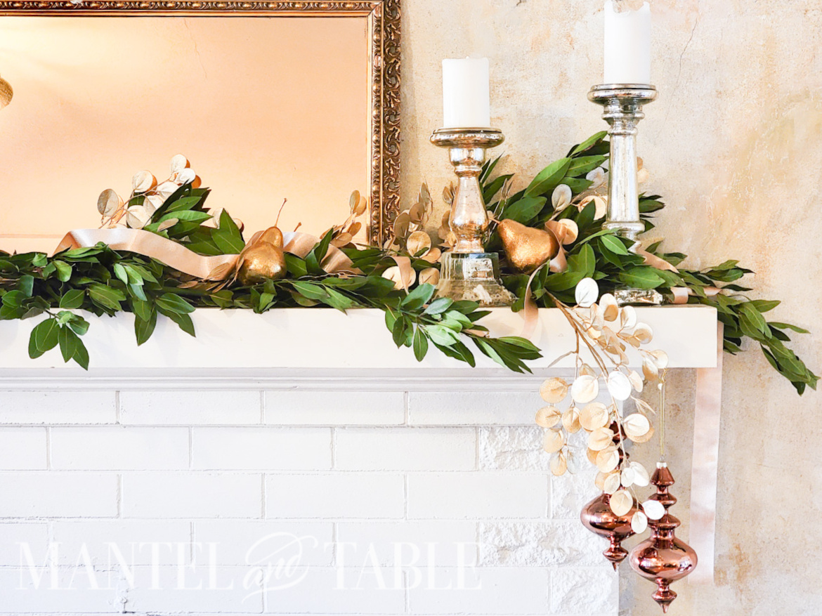 Bay leaf and gold garland on white mantel