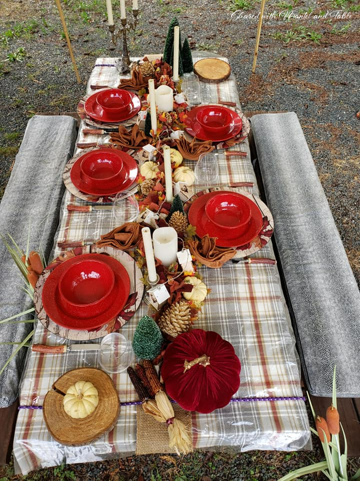 Picnic table set with fall leaves and white pumpkin garland centerpiece