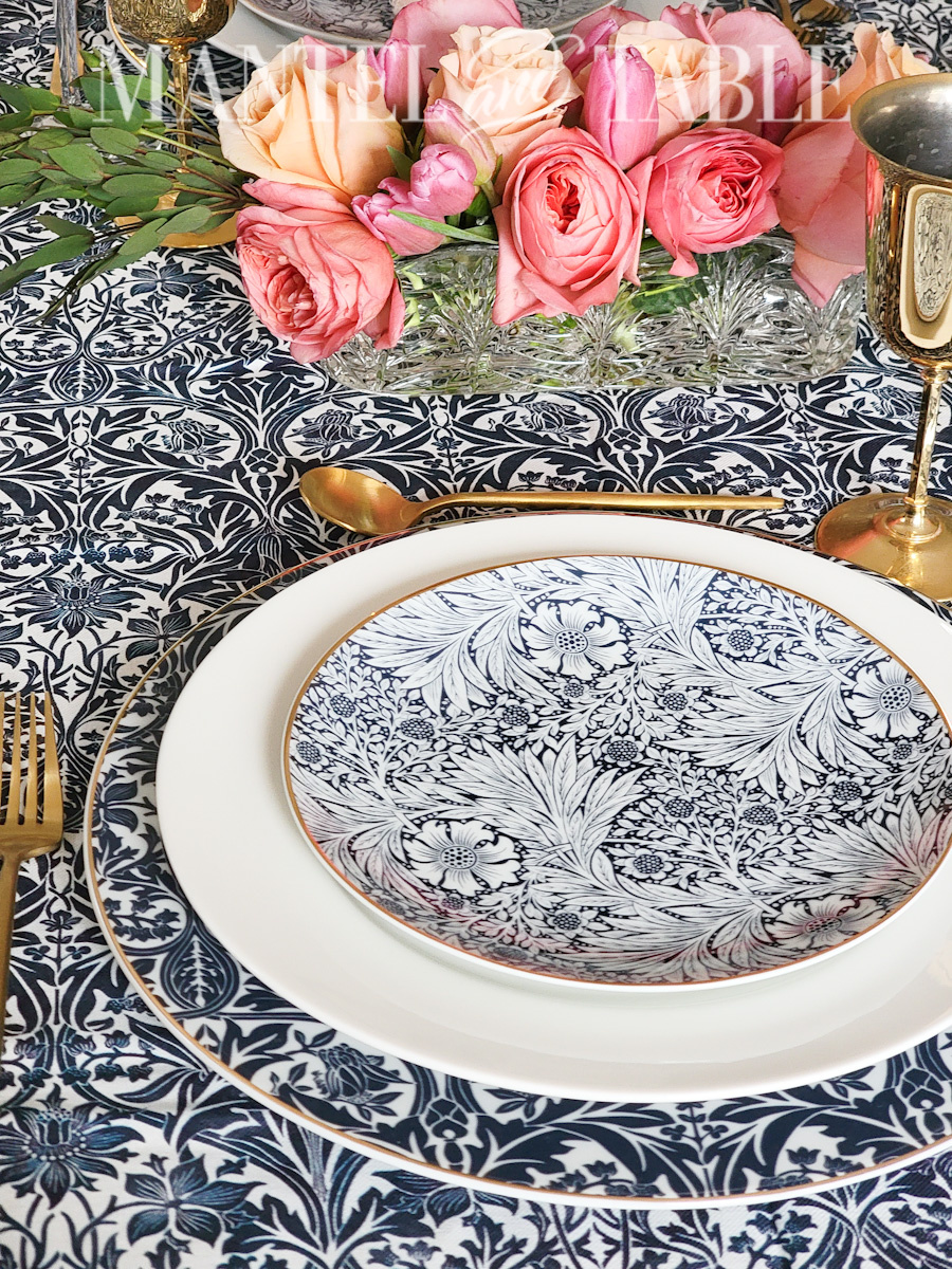 Closeup of blue patterned plate stack on a formal table