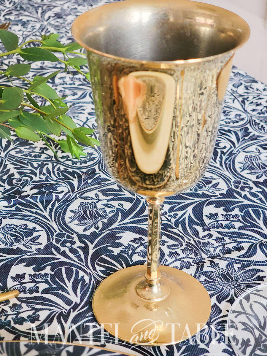 Gold goblet on a blue tablecloth