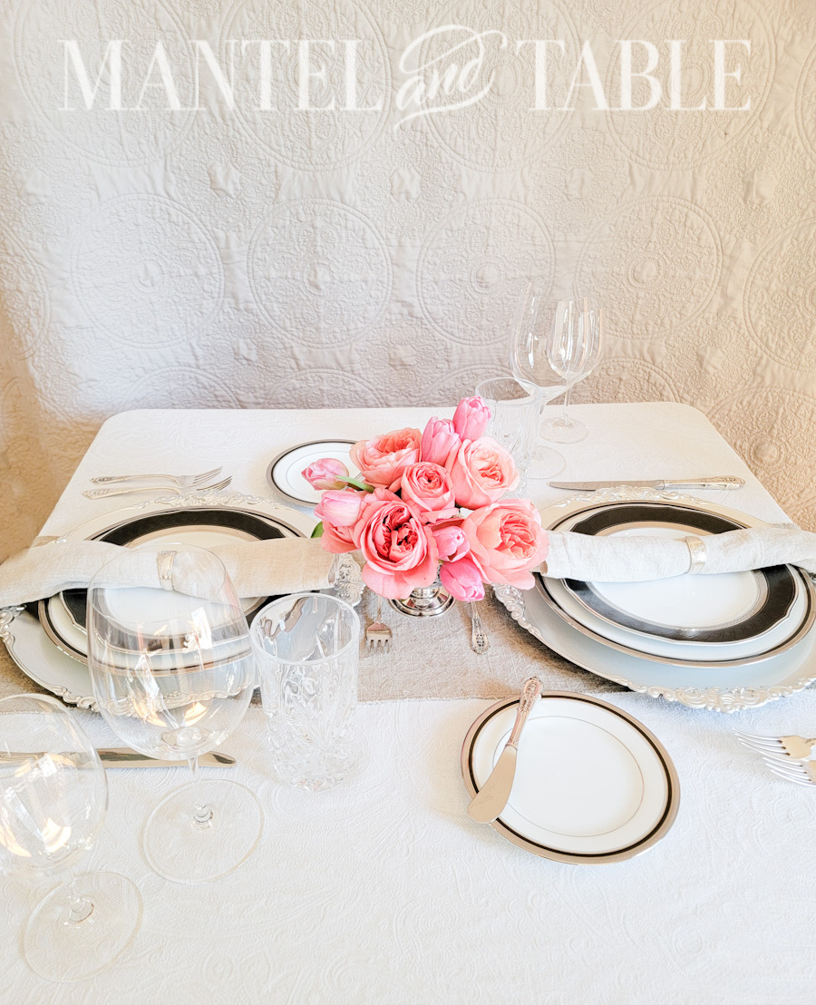 Fancy table setting with a taupe quilt background on the wall