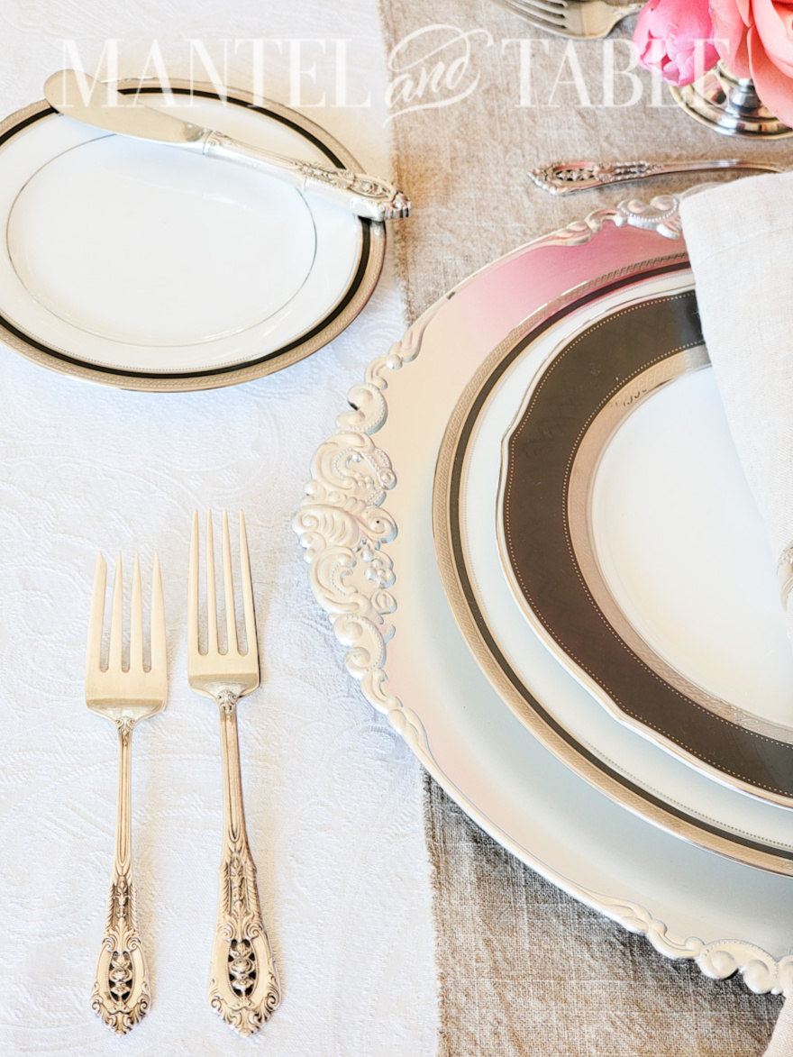 Overhead shot of Wallace Rose Point silver forks in a formal place setting
