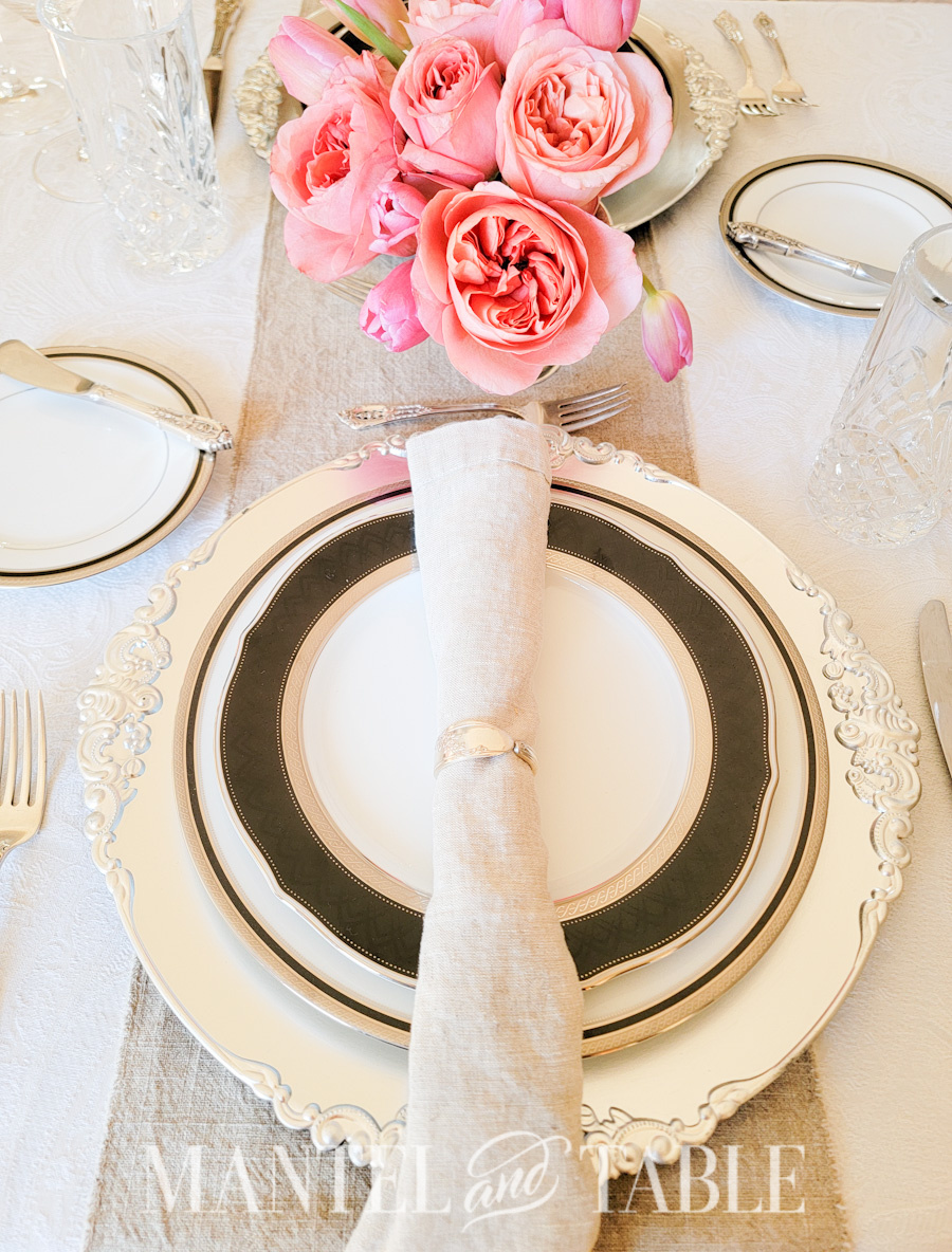 Neutral Pink Tablescape place setting with silver spoon handle napkin rings