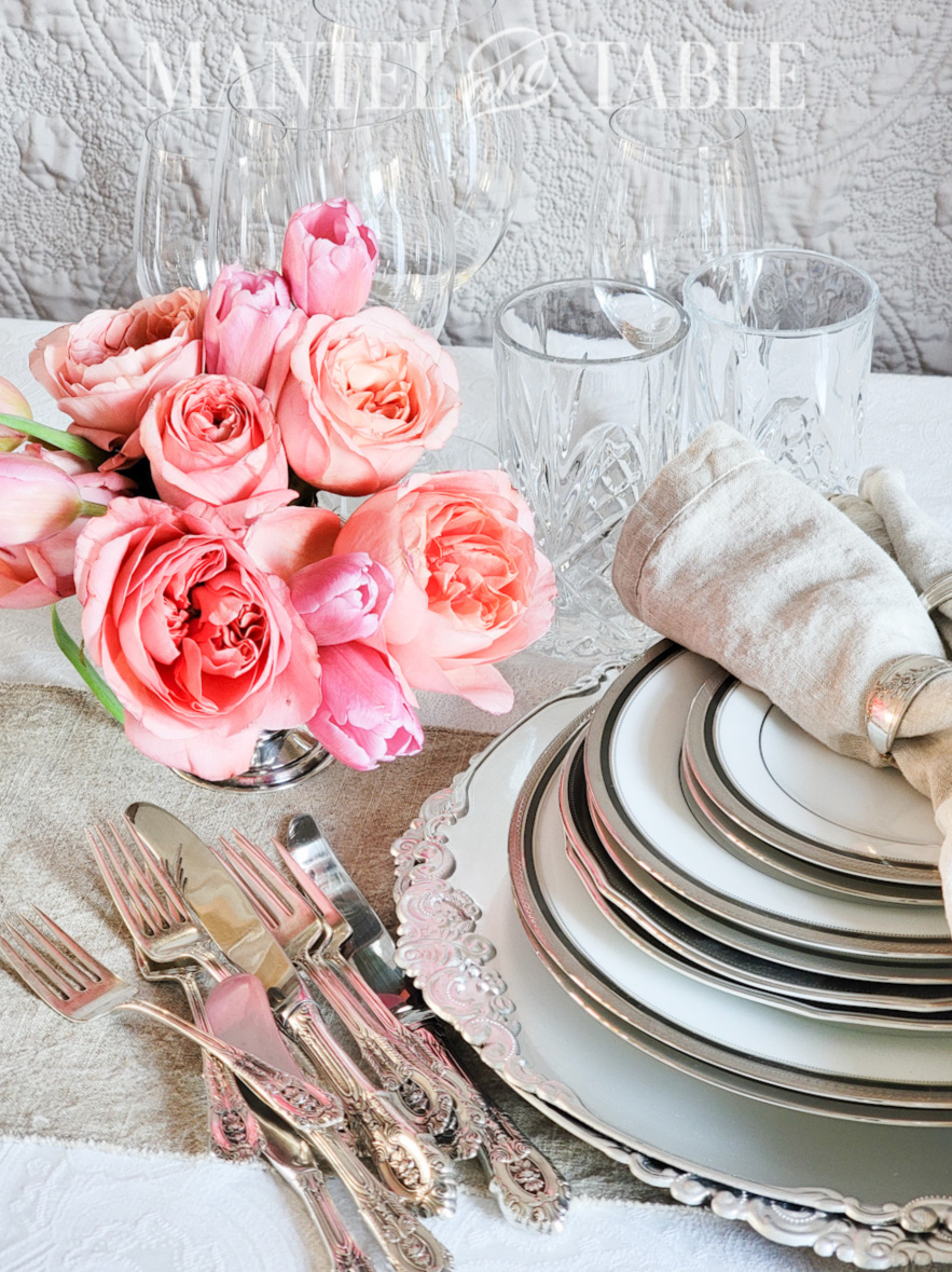 Pieces for a Neutral Pink Tablescape - stack of plates, pile of silverware, pink flowers