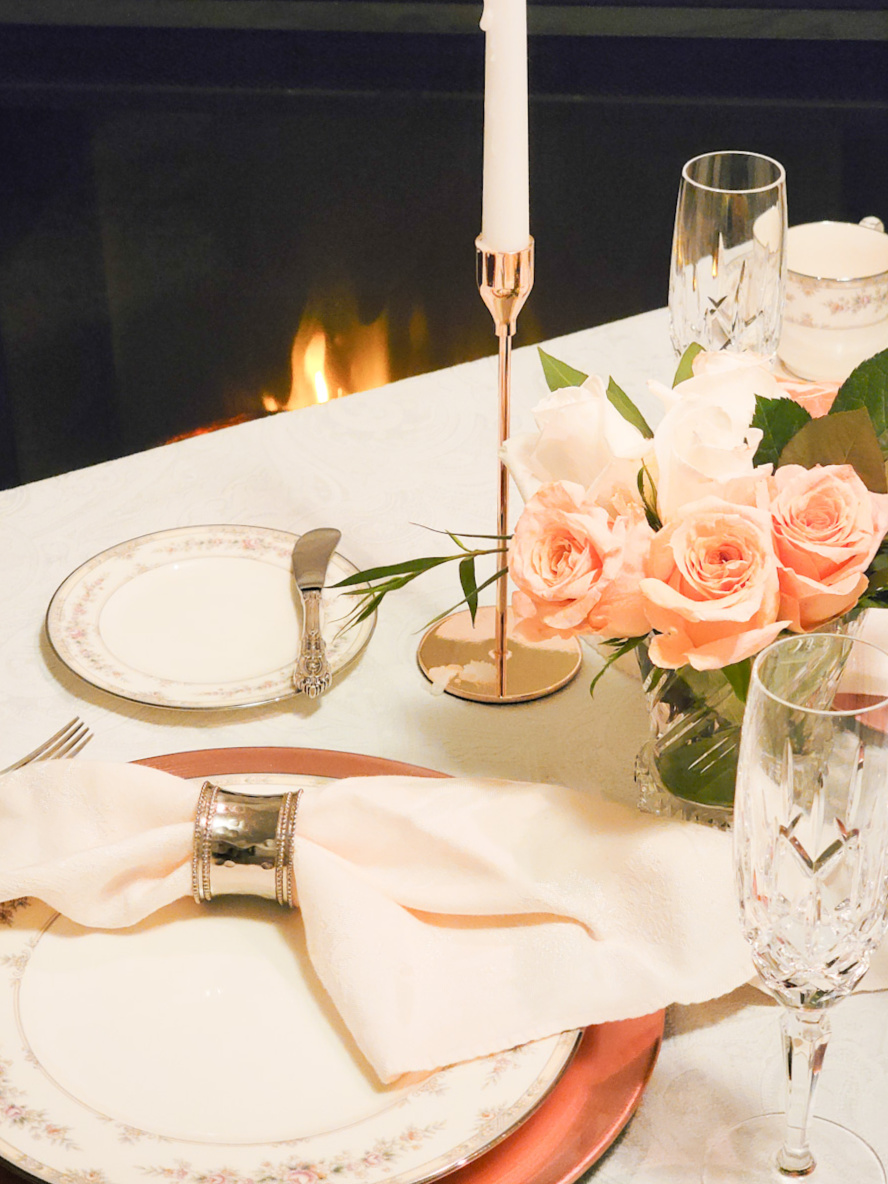 Closeup of peach rose centerpiece on formal table