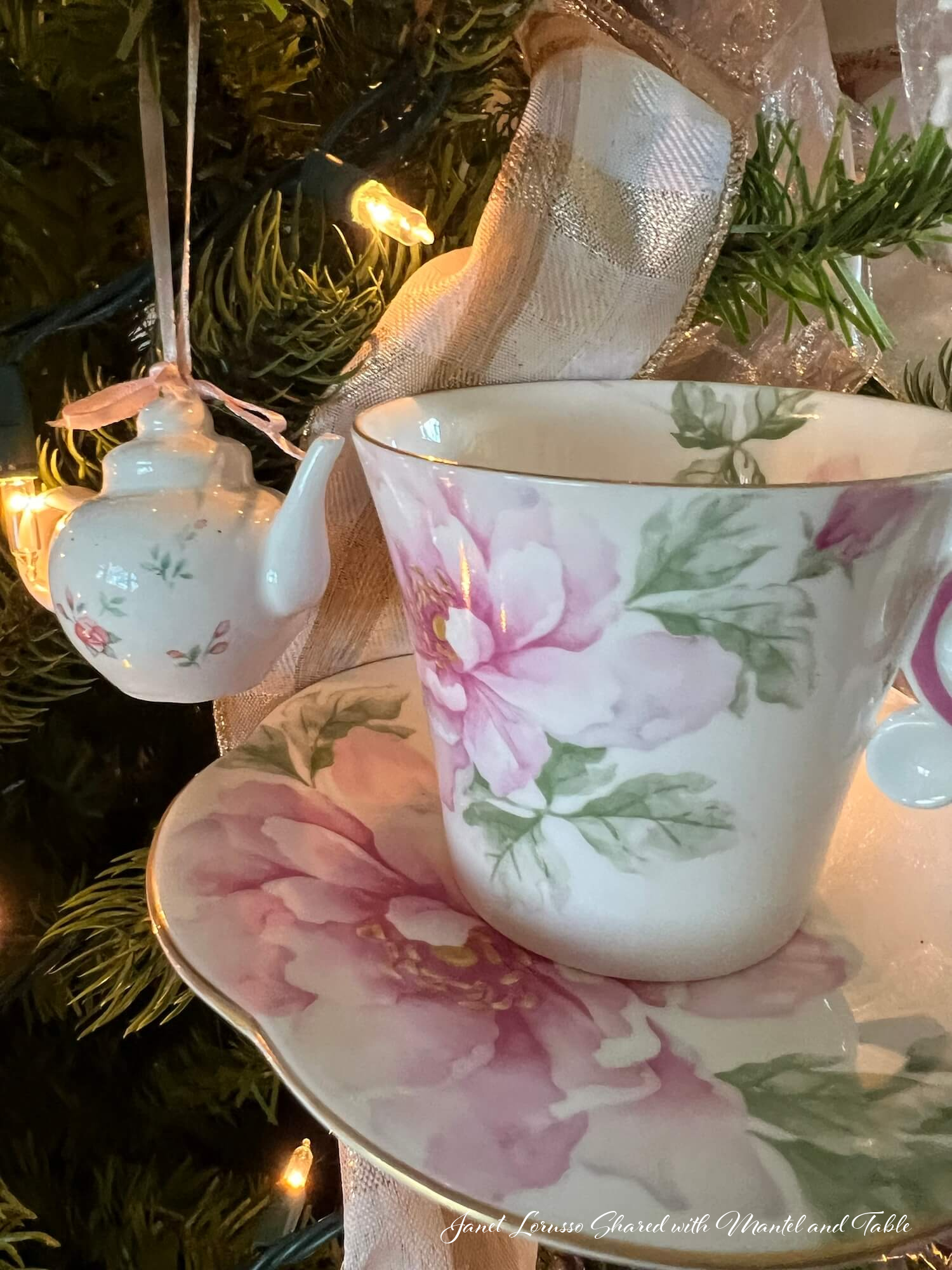 Closeup of pink flowered teacup and hanging teapot ornament