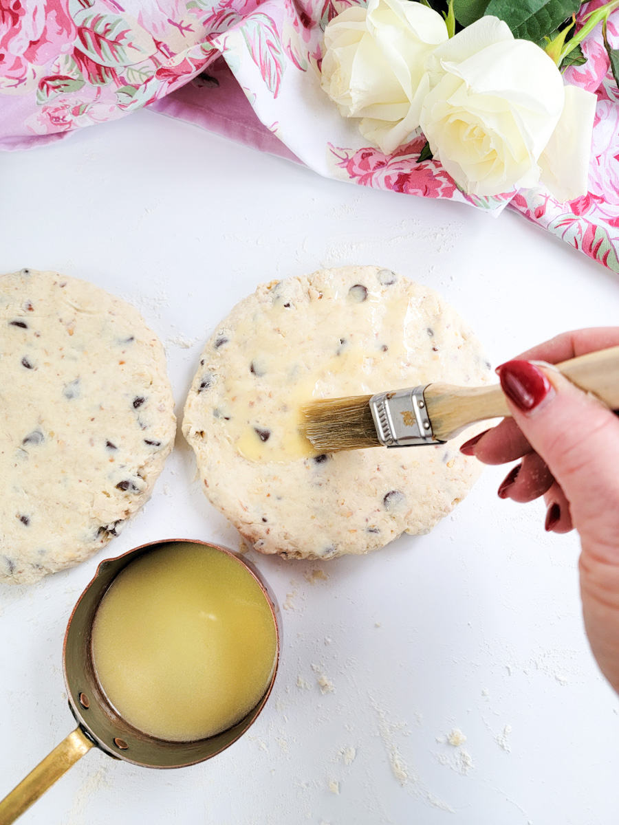 Brushing butter of rounds of dough