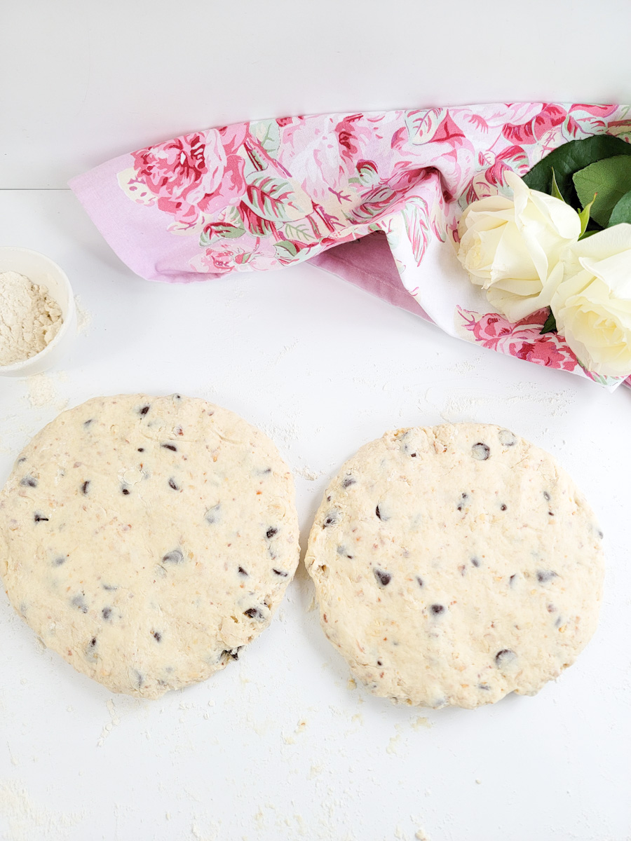 Two flat rounds of dough for cream scones