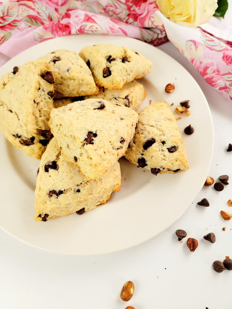 Plate of cream scones with chocolate chips and hazelnuts