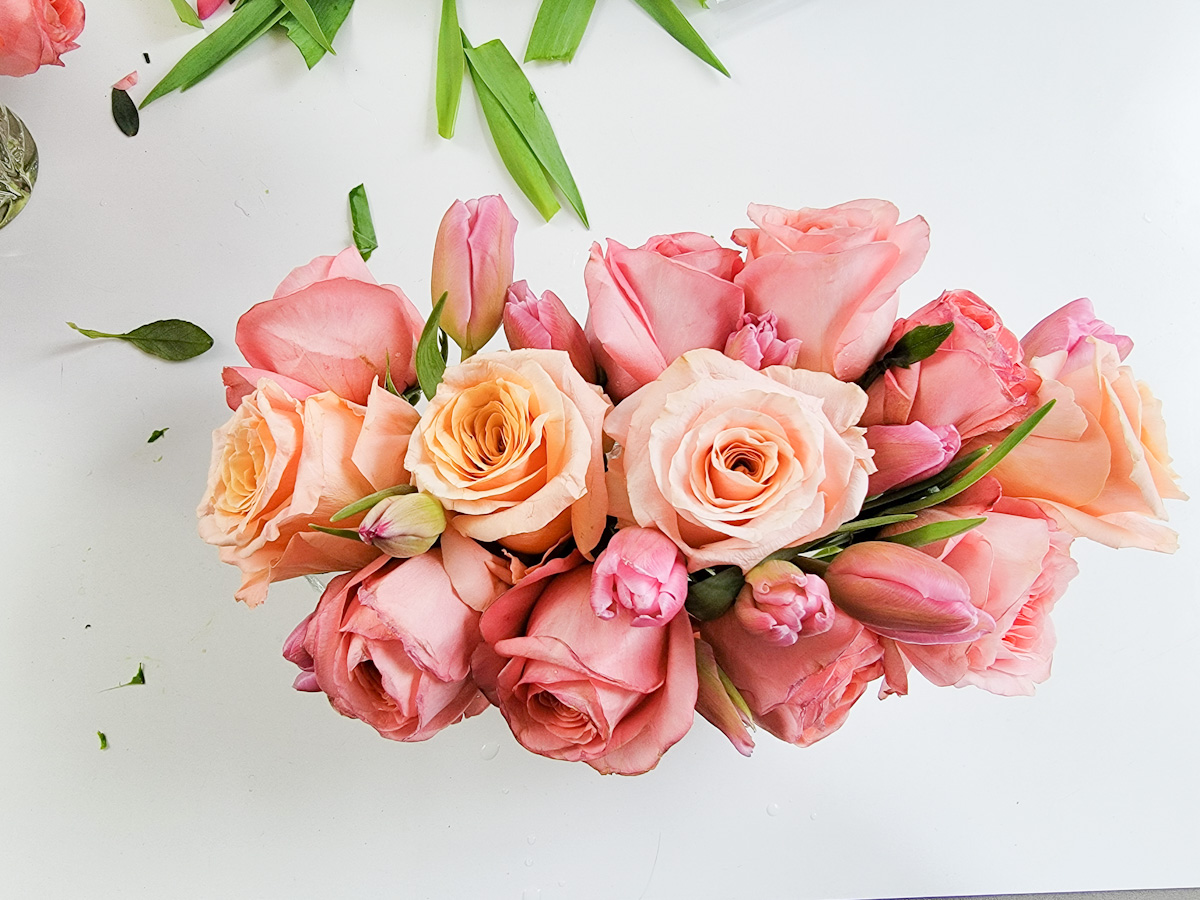 Pink and peach rose centerpiece with tulips from above