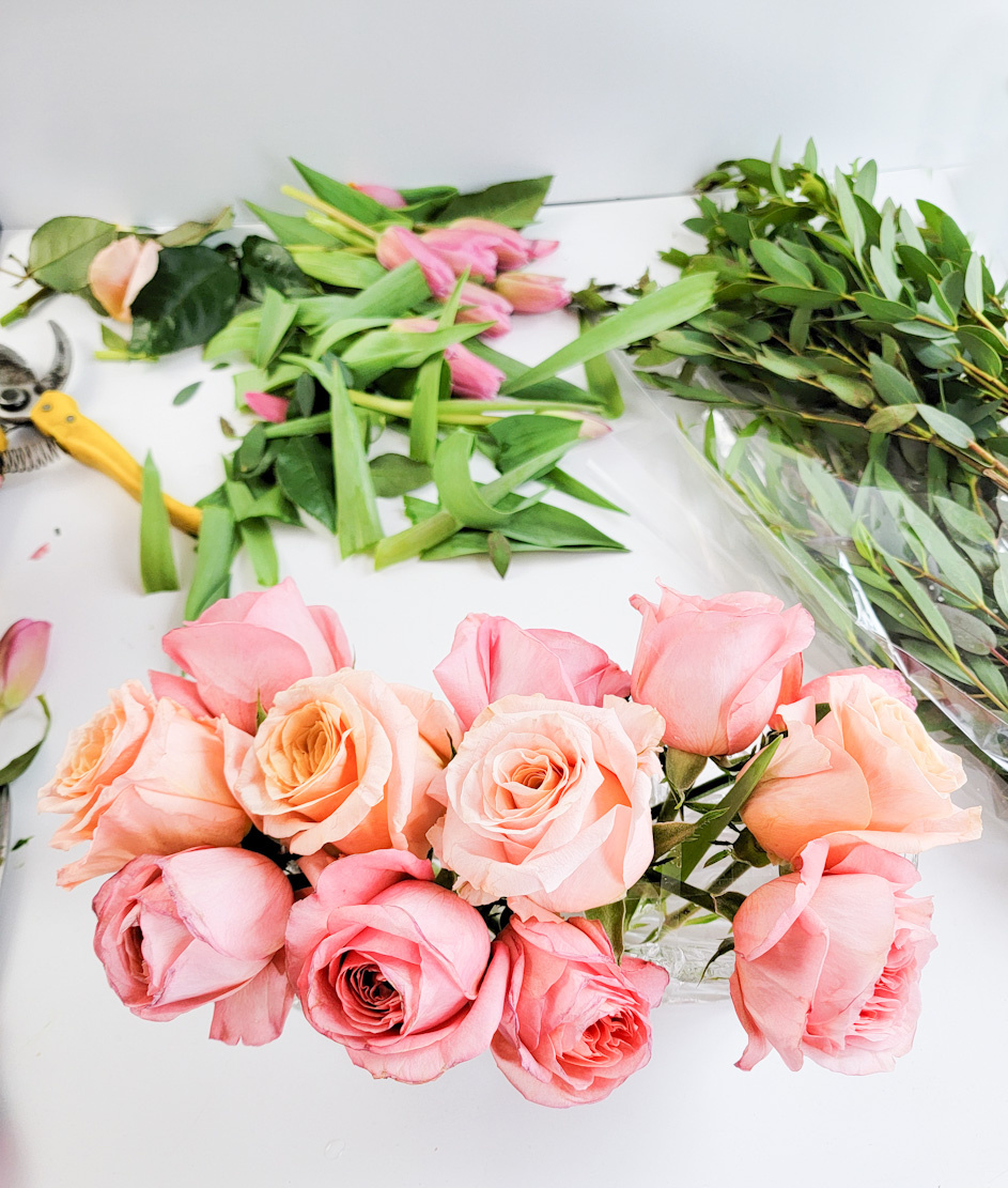 Pink and peach roses in process for a centerpiece