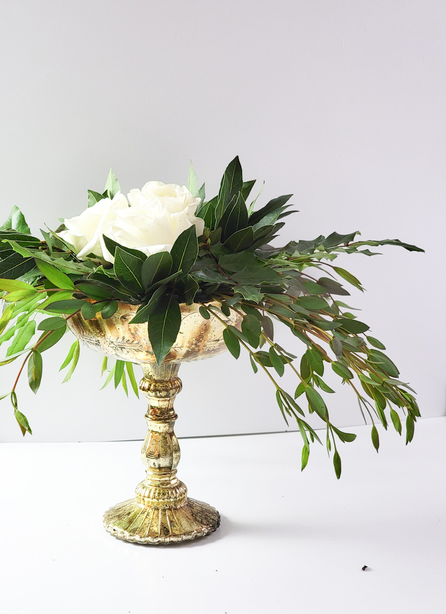 Side view of a winter flower arrangement with white roses