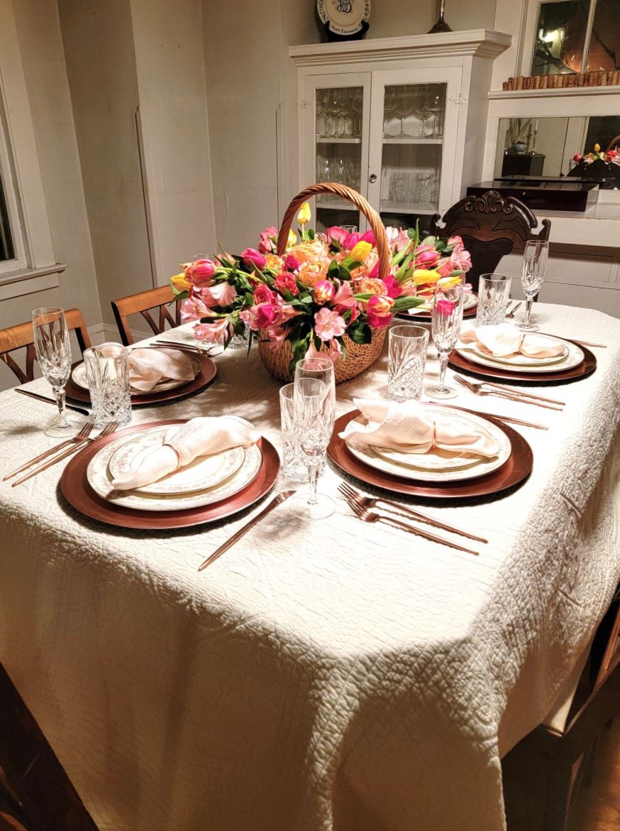 Side view of Spring garden tablescape using matelasse coverlet as a tablecloth