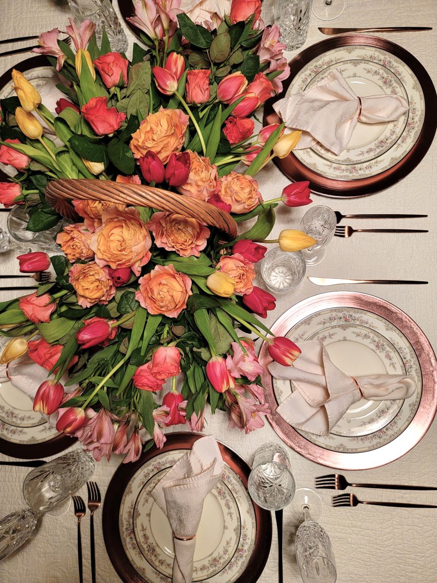 Top view of formal table with flower centerpiece in basket